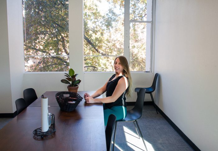 Local California office worker seated at table